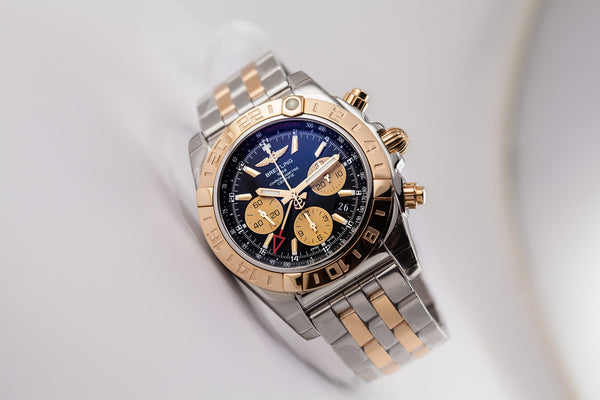 Breitling Chronomat 44 GMT 18kt Gold/SS Black Dial - The Luxury Well